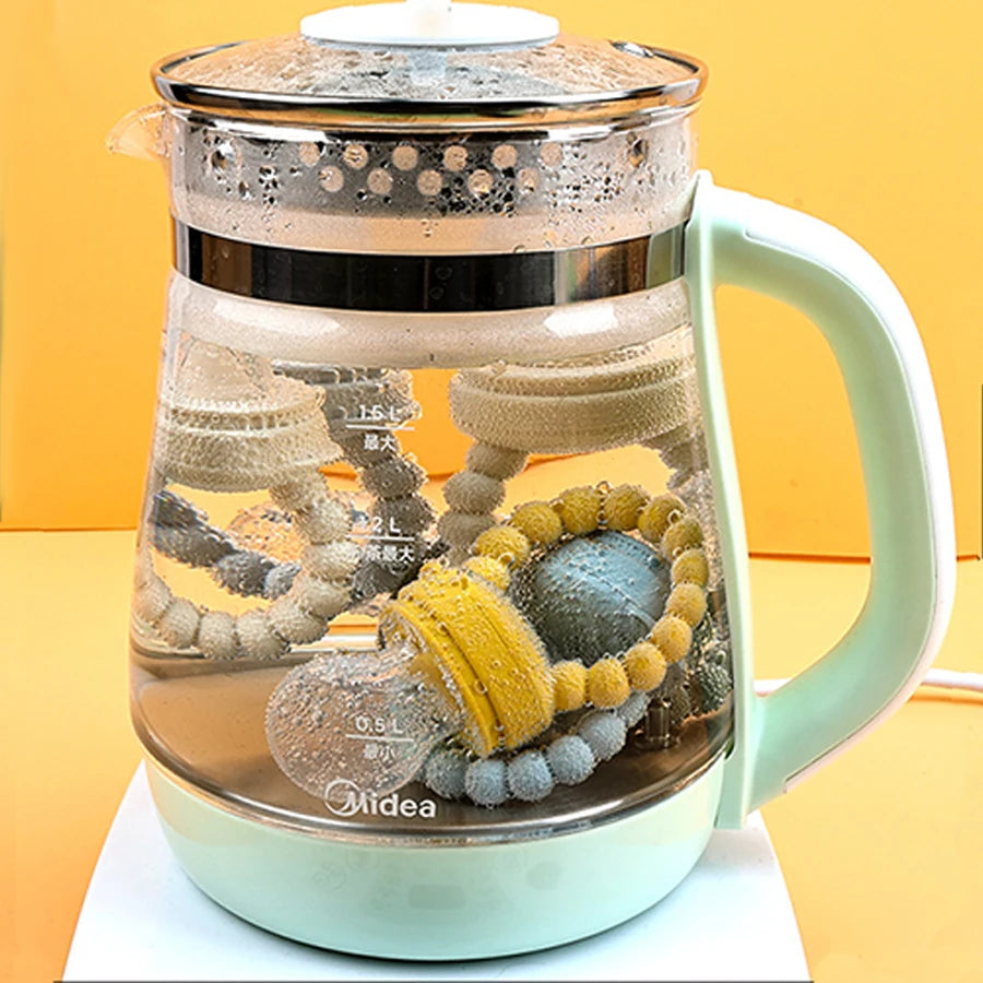 Glass teapot with colorful teething toys on a yellow background