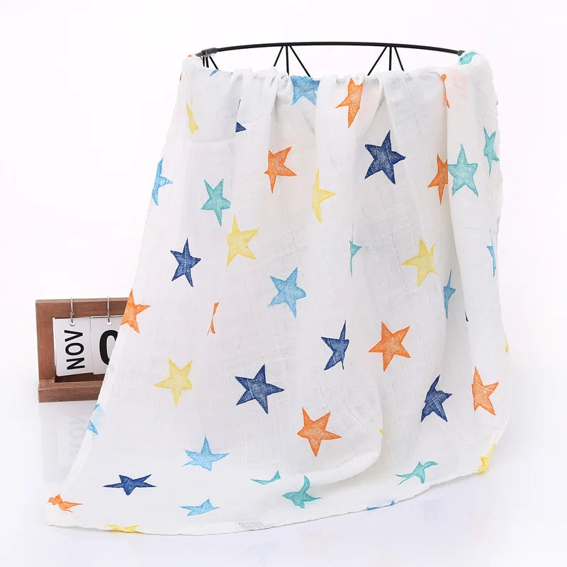 White blanket with colorful star patterns draped over a black metal rack.
