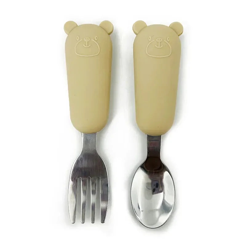 Set of bear-shaped handles fork and spoon on a white background