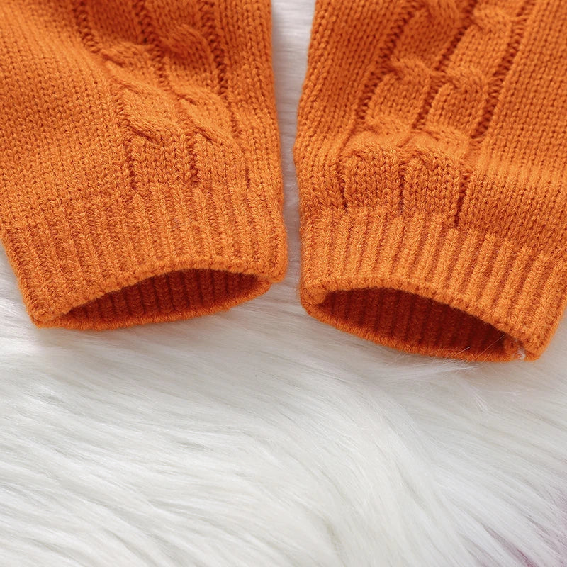 Close-up of orange knitted mittens on a white background