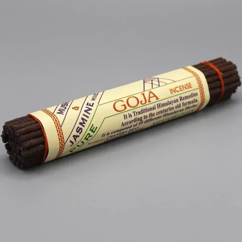 Roll of Goja incense with a label on a gray background