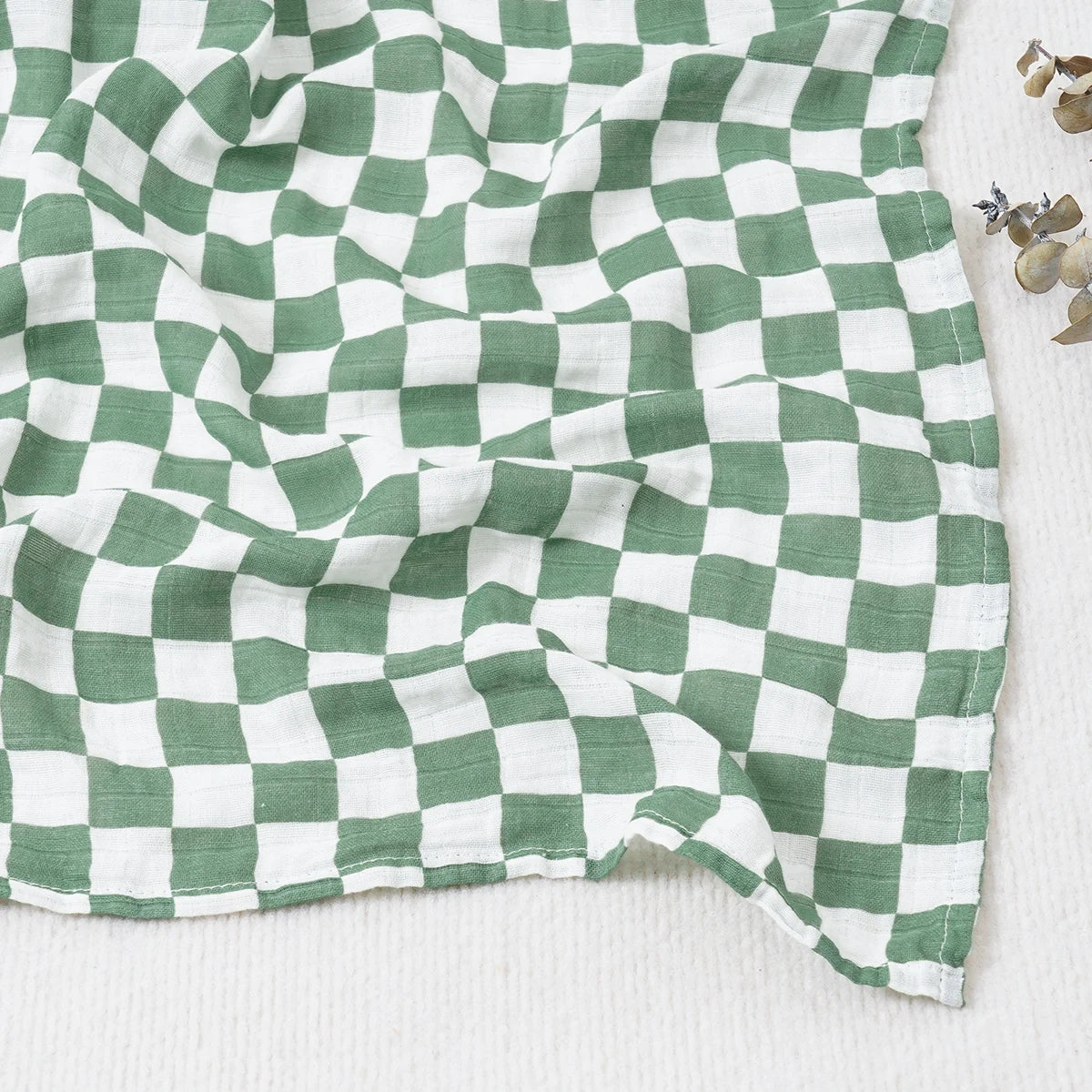 Green and white checkered fabric on a white background