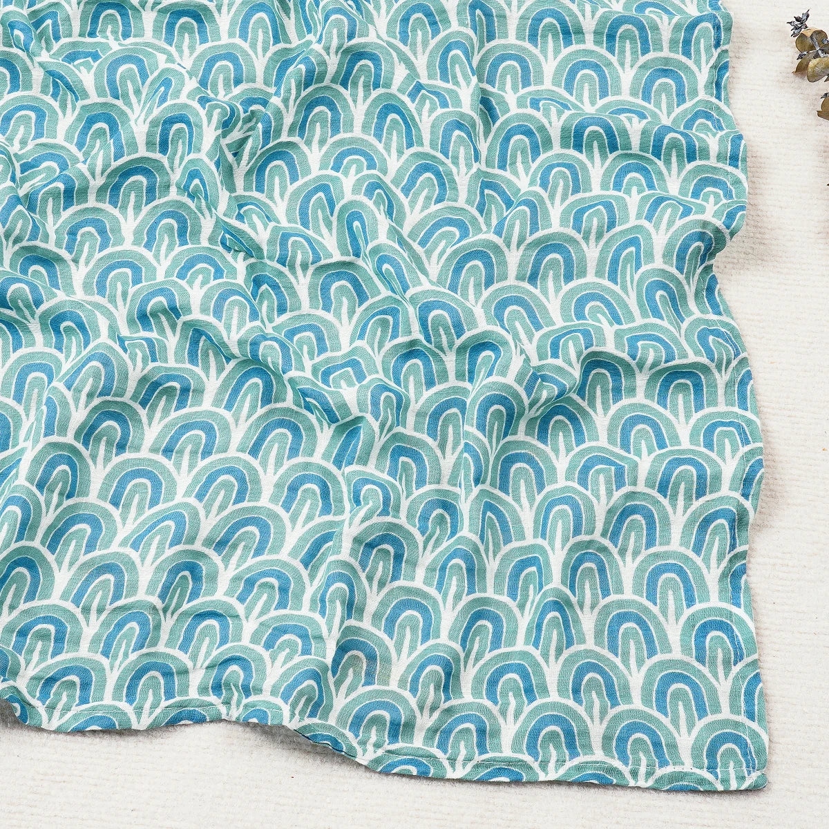 Textile with blue and green wave pattern on a white background