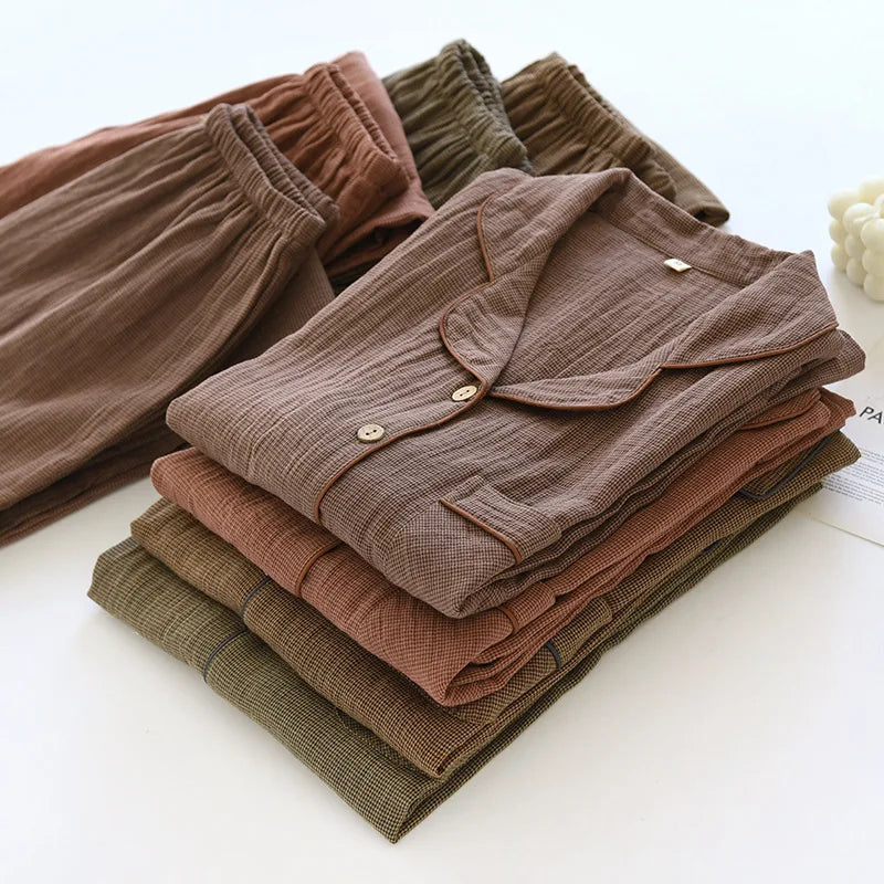Stack of folded brown pyjamas on a white surface