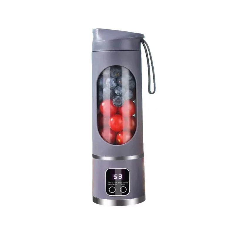 Gray portable blender with red liquid and ice cubes on a white background