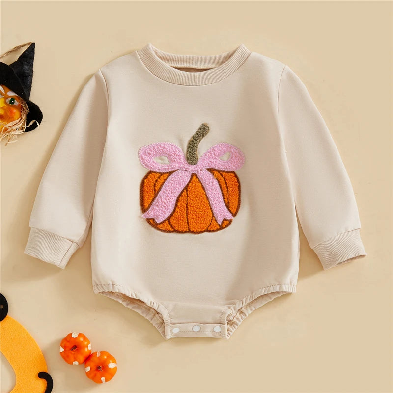 Baby onesie with pumpkin design on a beige background