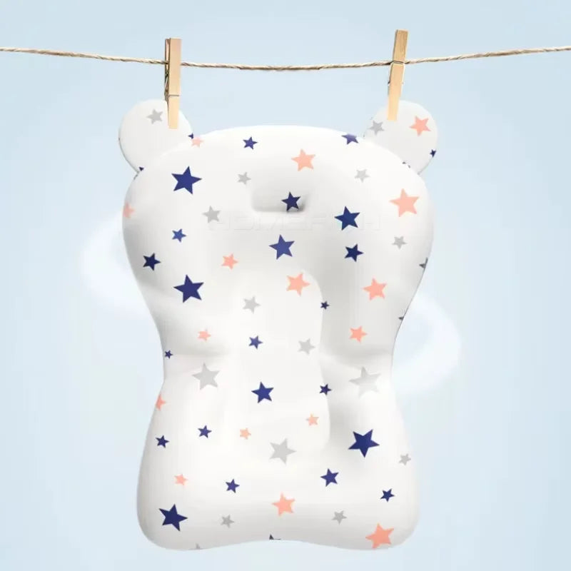White bear-shaped pillow with star patterns hanging on a clothesline against a light blue background