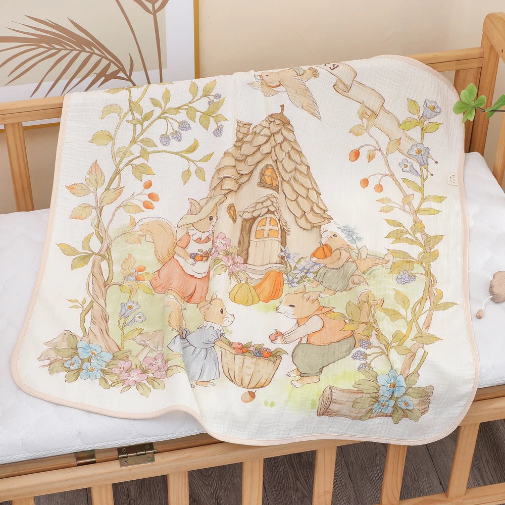 Baby towel with fairy tale design featuring mice and a house on a crib.