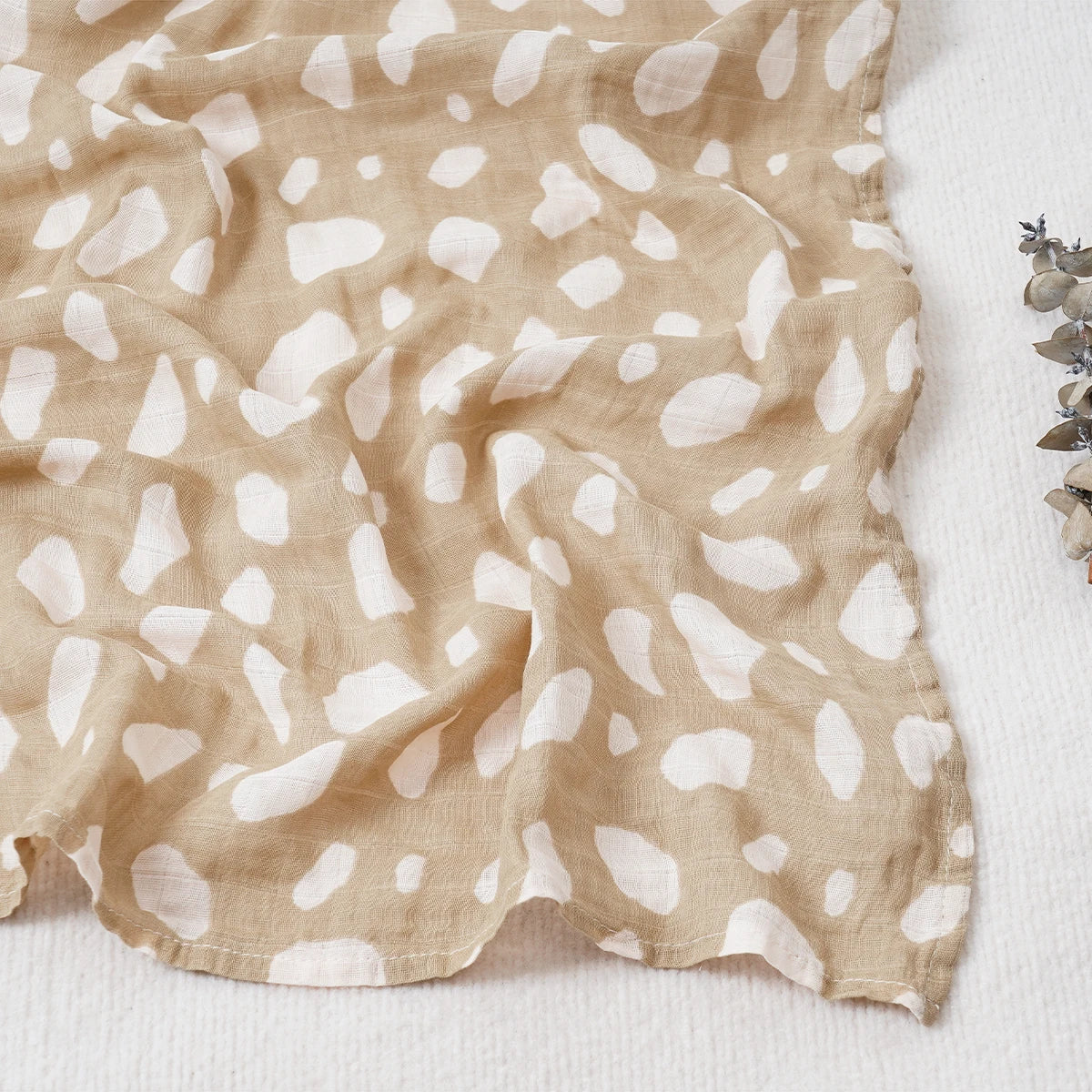 Beige fabric with white abstract pattern on a white background
