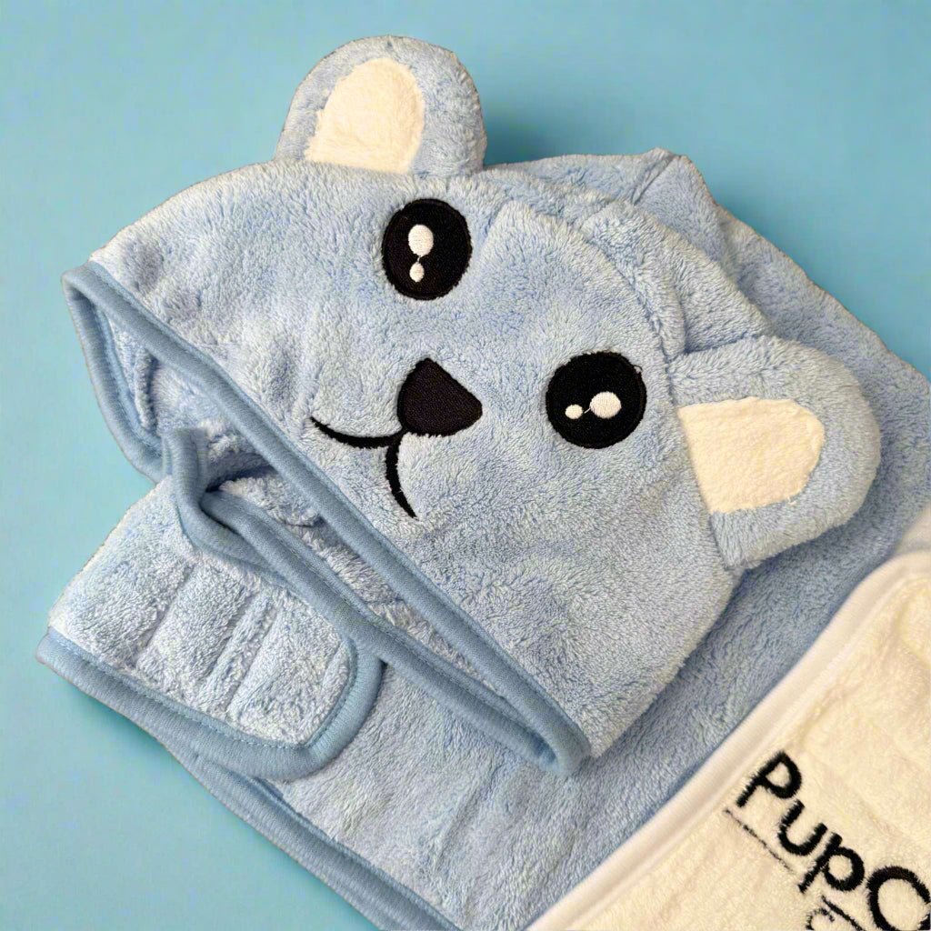 Blue towel with a cartoon face design on a light blue background