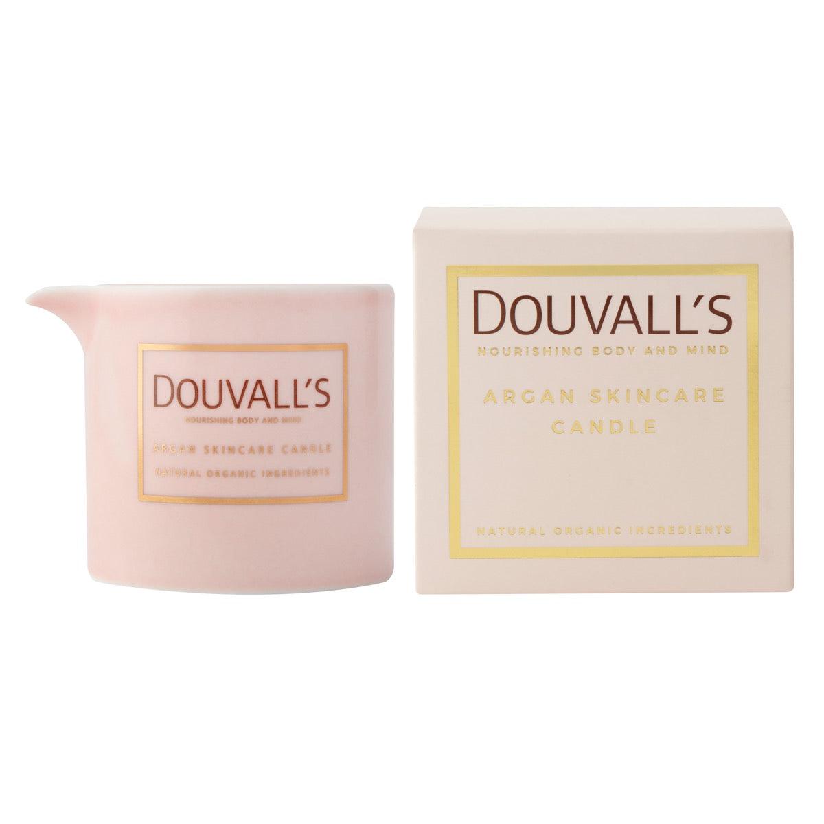 Pink skincare candle and packaging with 'Douvall's' branding on a white background