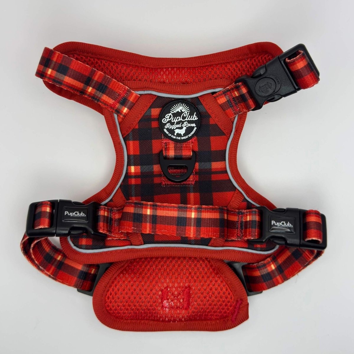 Red plaid dog harness with visible branding on a white background