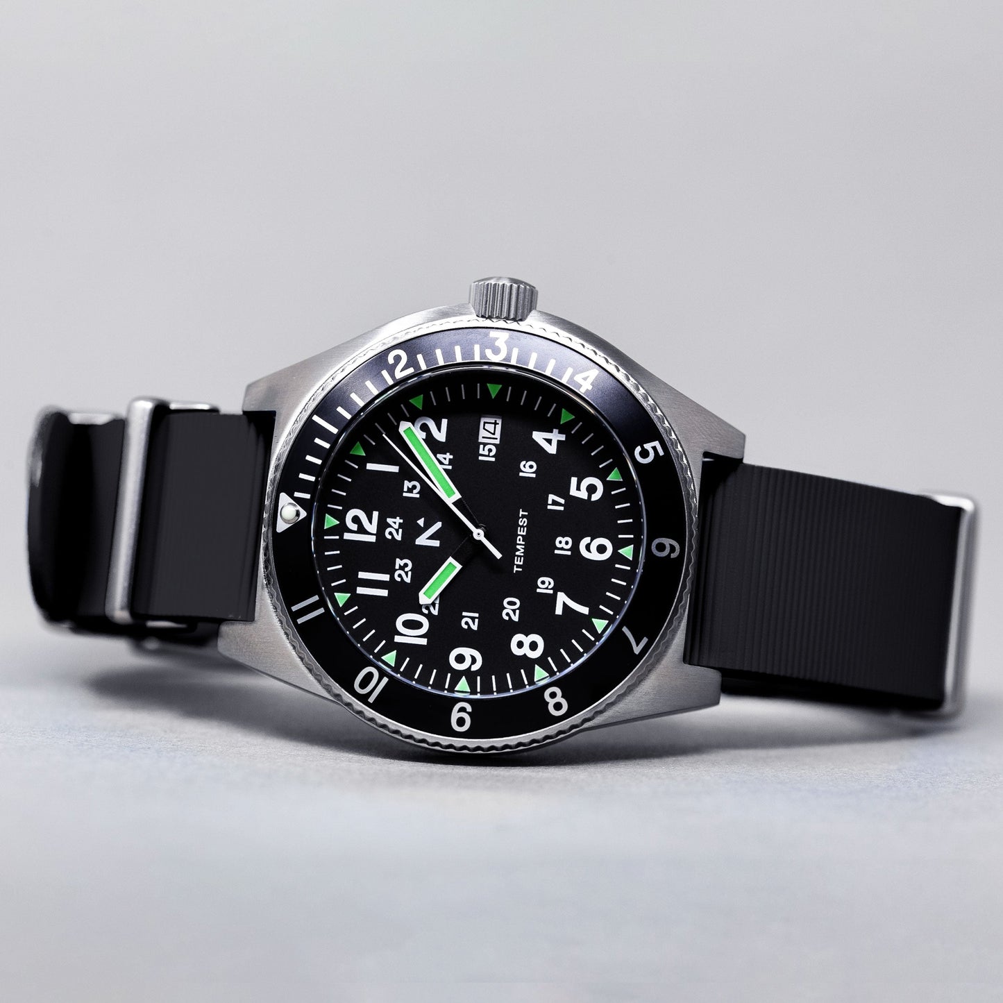 Wristwatch with black strap and green accents on a light gray background