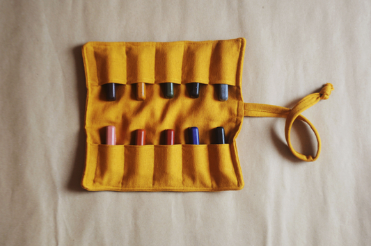 Yellow crayon holder with various crayons on a beige background