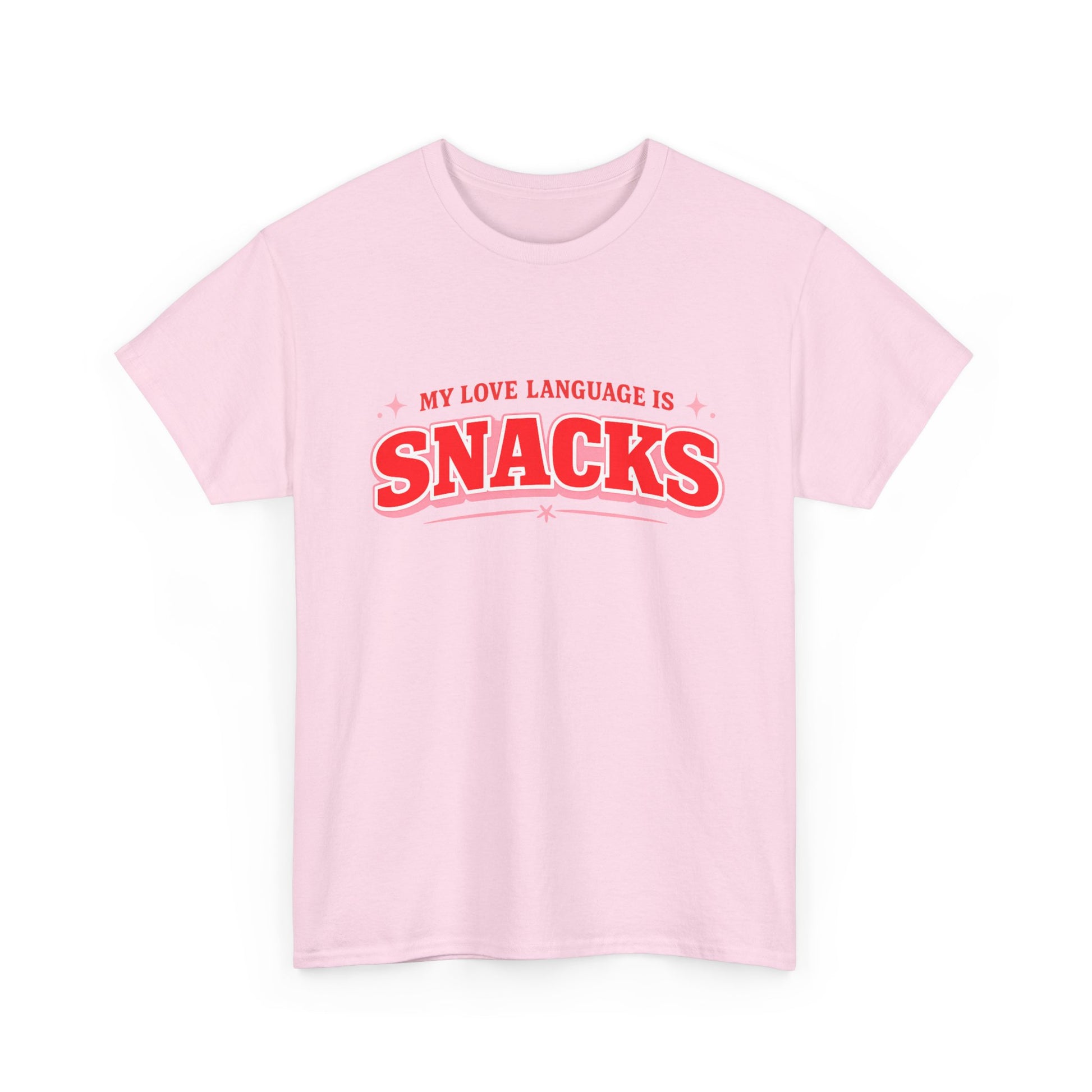 A light pink short-sleeve crewneck t-shirt with a red graphic text print reading 'MY LOVE LANGUAGE IS SNACKS' on the chest, displayed against a solid white background.
