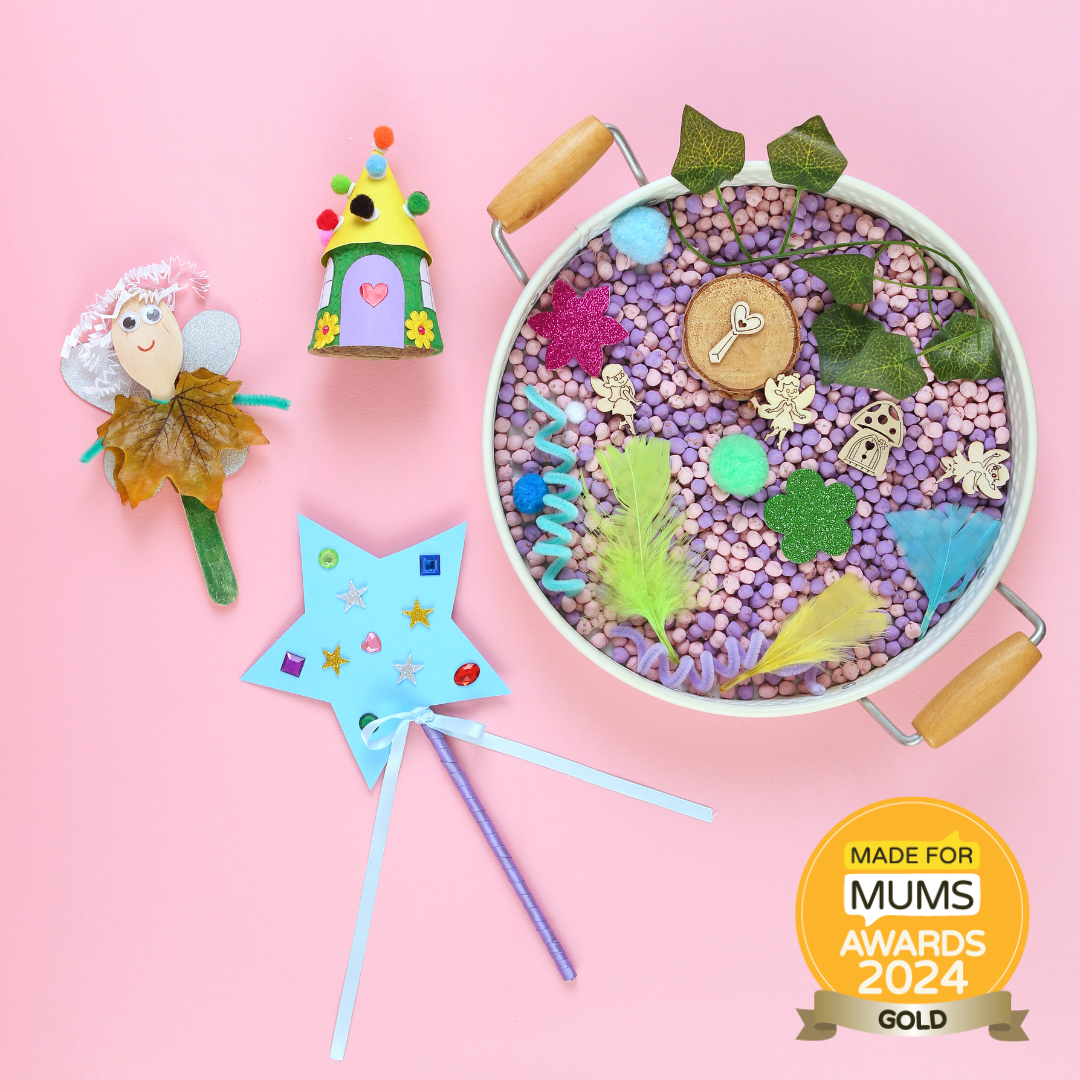 Fairy-themed playset with fairy doll, house, wand, and decorative bowl on a pink background, featuring a 'Made for Mums Awards 2024 Gold' badge.
