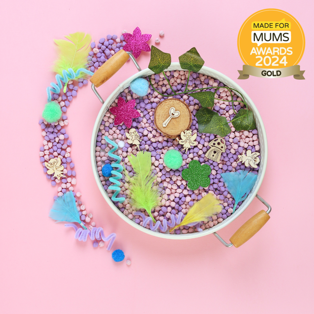Colorful sensory bin with toys on a pink background, featuring the Made for Mums Awards 2024 Gold badge.