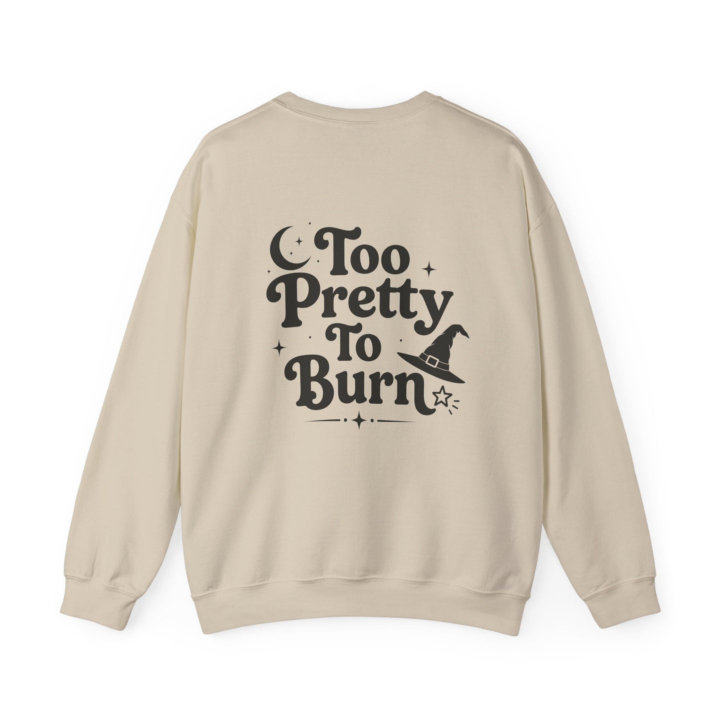 A beige crewneck sweatshirt shown from the back, featuring a black graphic print that reads 'Too Pretty To Burn' alongside a small witch hat illustration.
