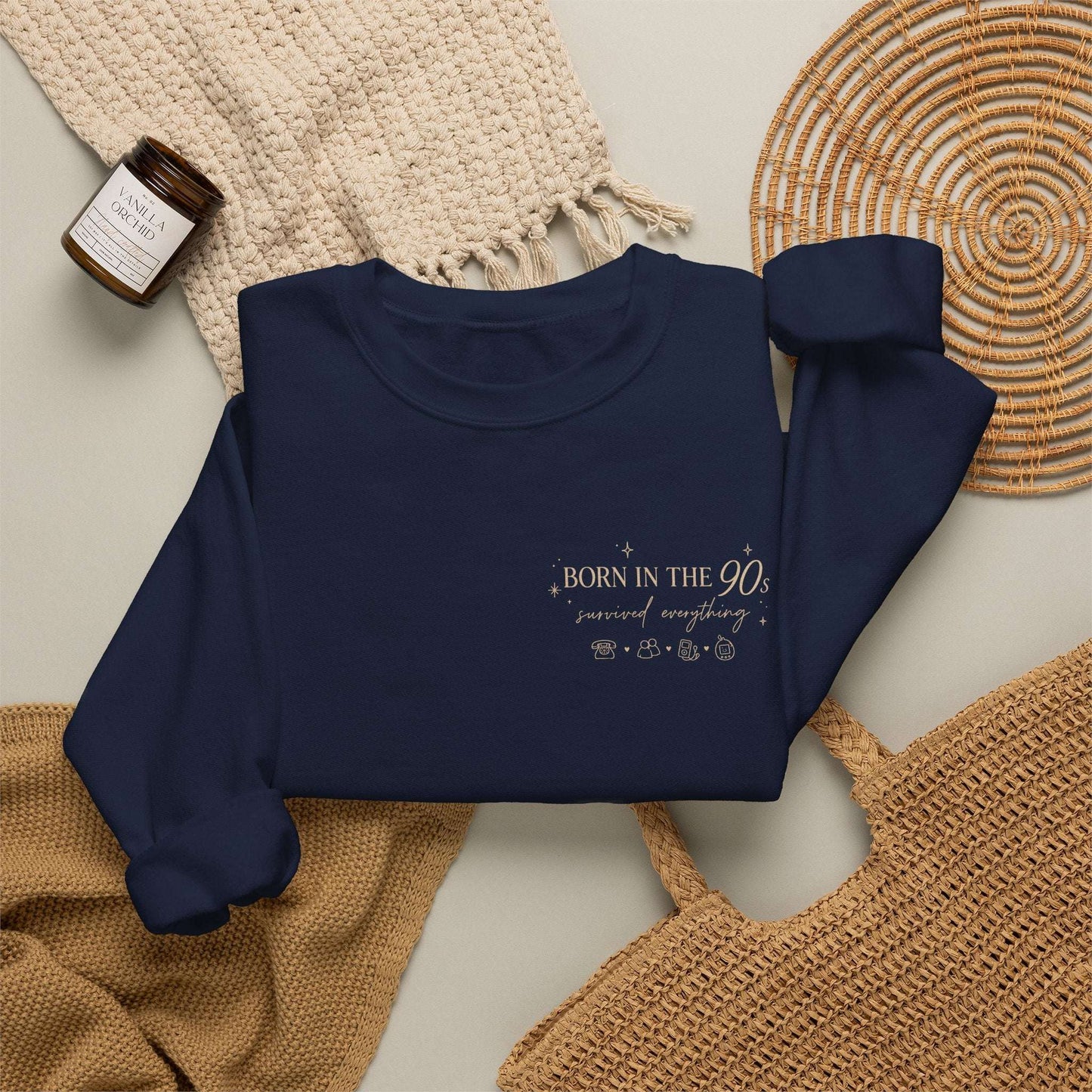 Navy blue sweatshirt with summer design on a textured surface