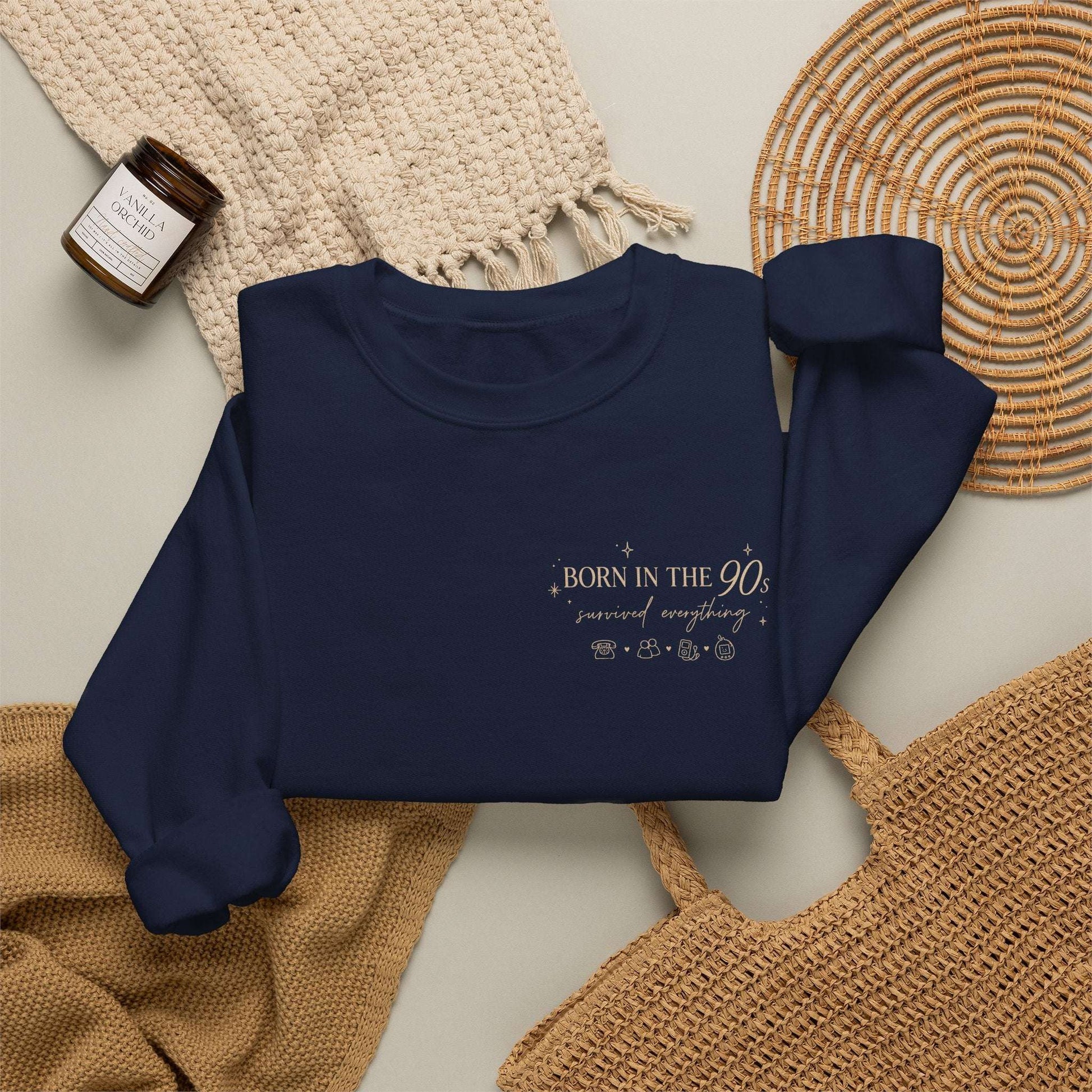 Navy blue sweatshirt with summer design on a textured surface