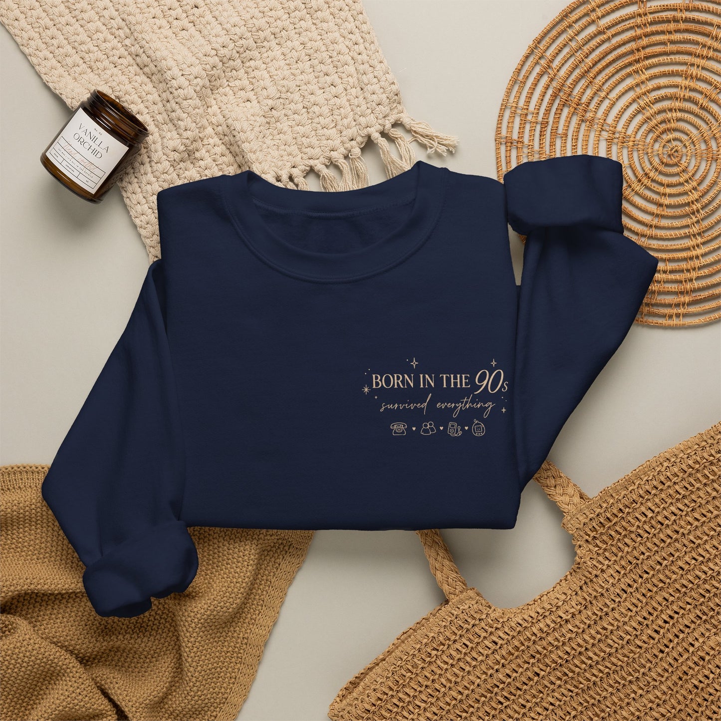 Navy blue sweatshirt with summer design on a textured surface
