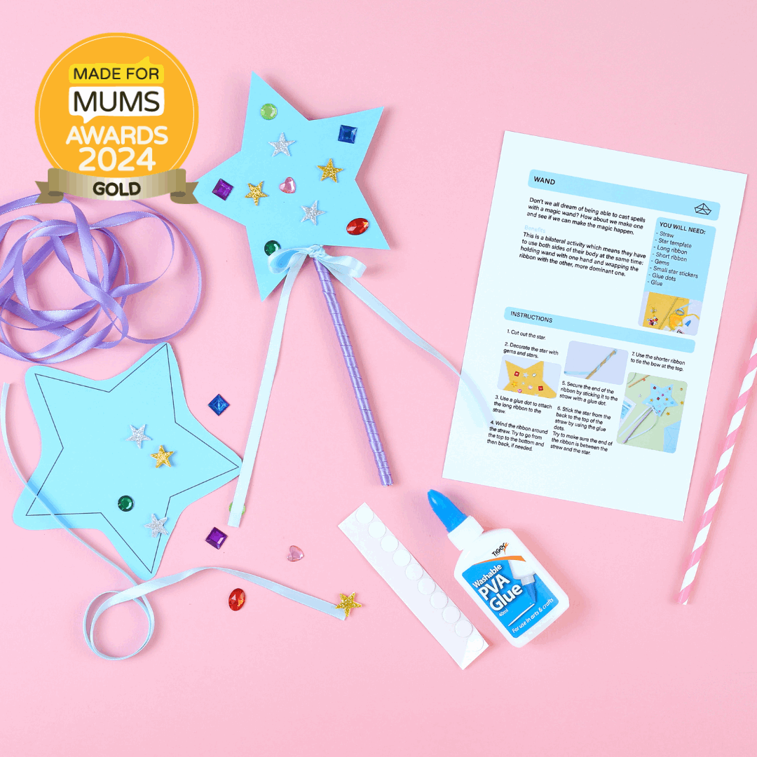 Craft materials and a gold award on a pink background