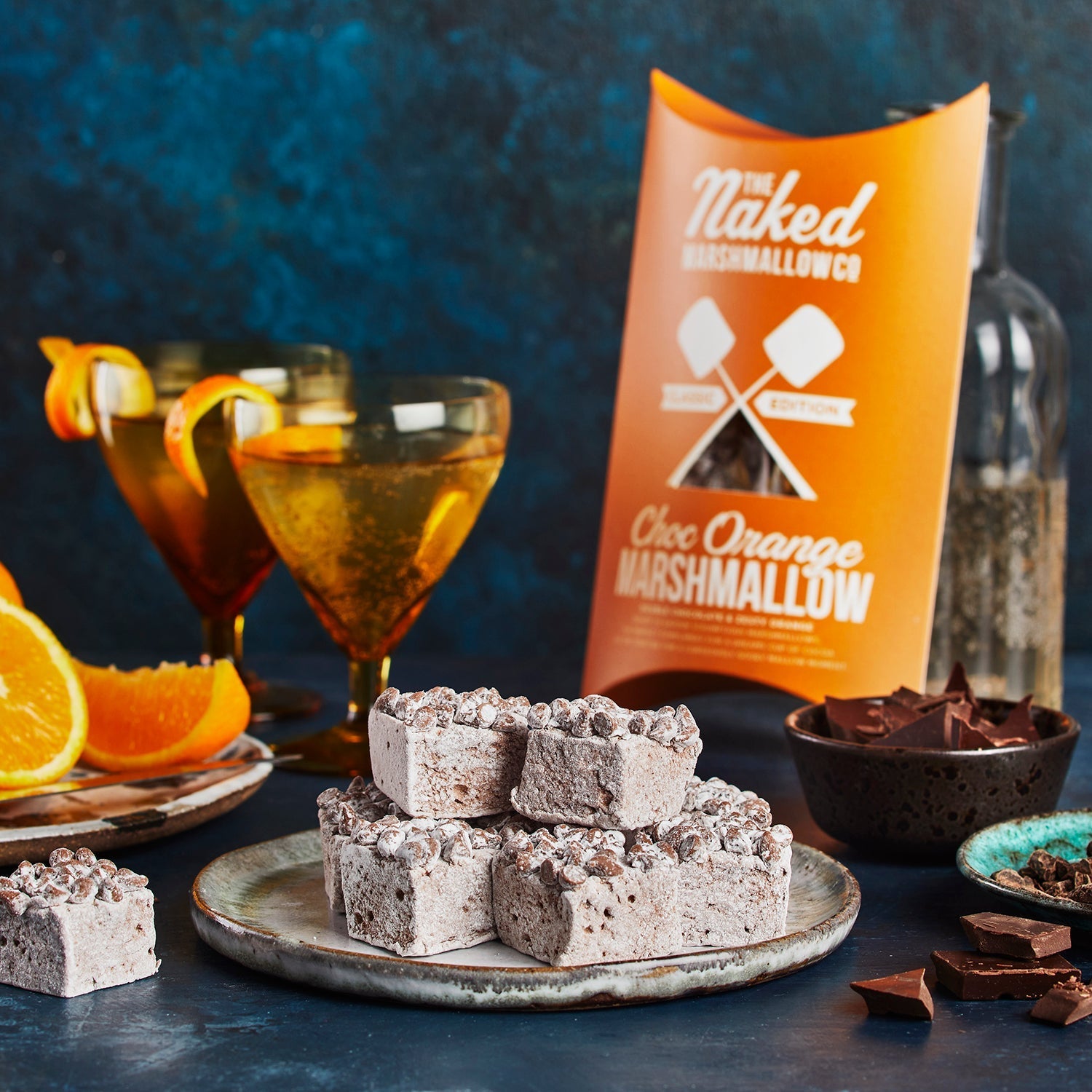 Choc Orange Marshmallow with cocktails and marshmallow packaging on a dark background