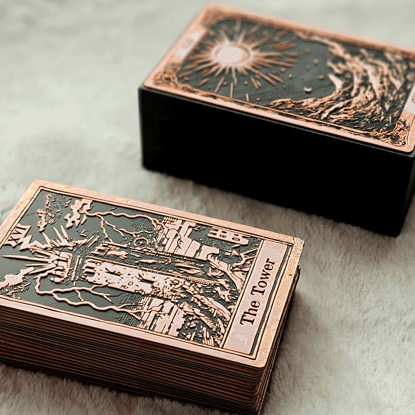 Decorative playing cards with 'The Tower' card visible, on a textured surface.