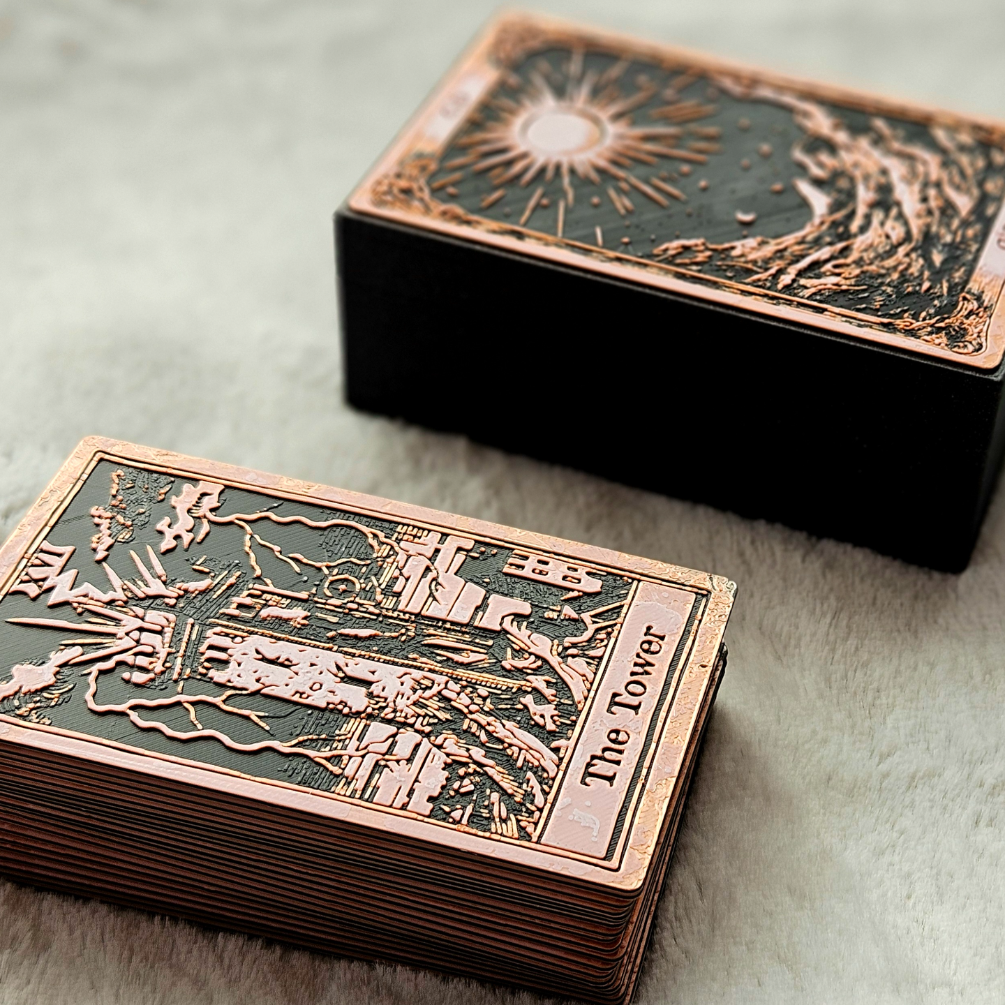 Decorative playing cards with 'The Tower' card visible, on a textured surface.