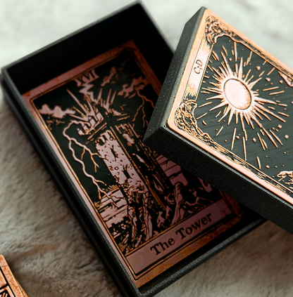 Close-up of a tarot card with 'The Tower' symbol and a decorative box.