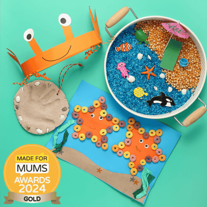 Children's craft items including a crab hat, fish, and ocean-themed sensory bin on a teal background with 'Made for Mums Awards 2024 Gold' badge.