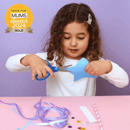 Child cutting blue paper with scissors on a pink table against a purple background, with 'Made for Mums Awards 2024 Gold' badge.