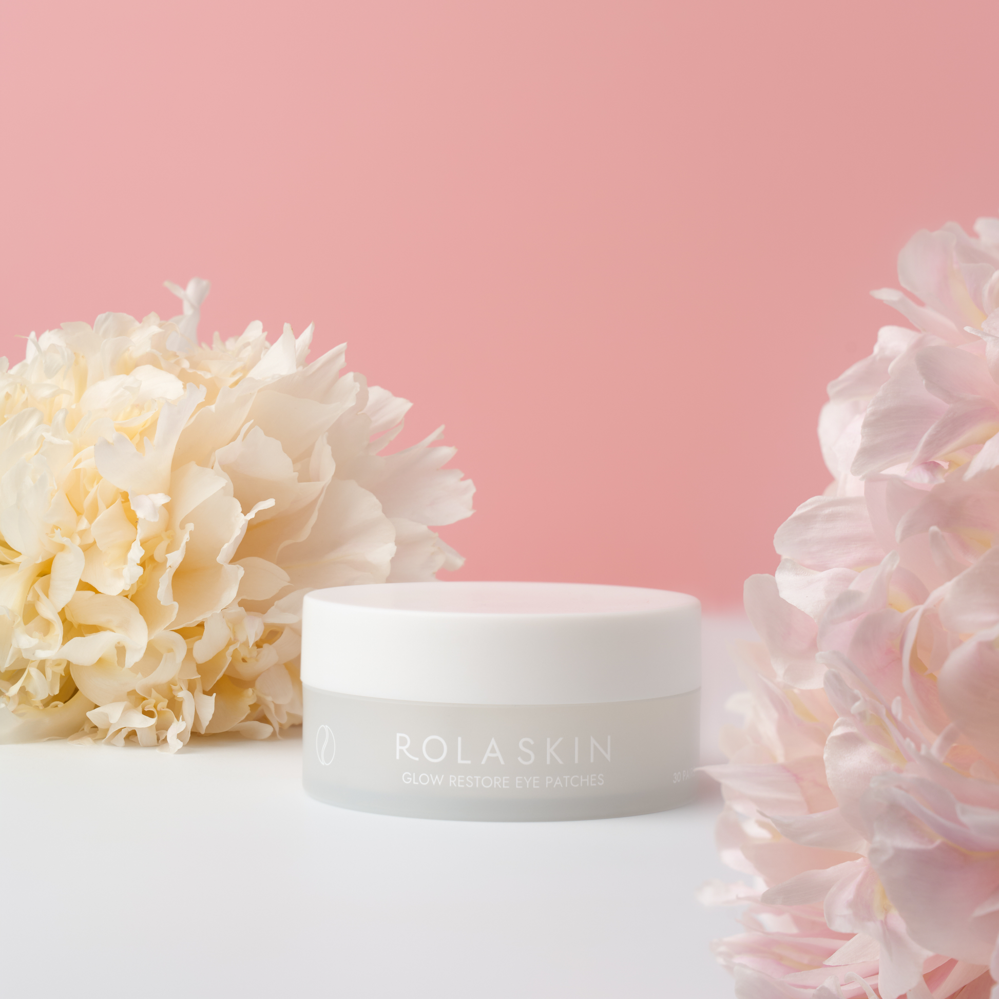White jar with 'ROLASKIN' branding surrounded by flowers on a pink background