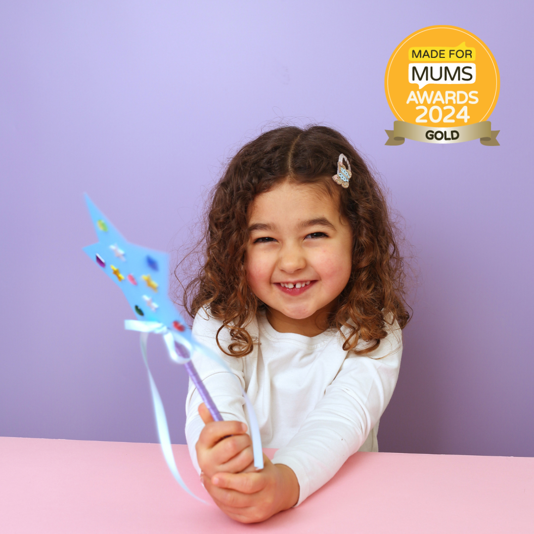 Child holding a colorful toy with 'Made for Mums Awards 2024 Gold' badge on a purple background