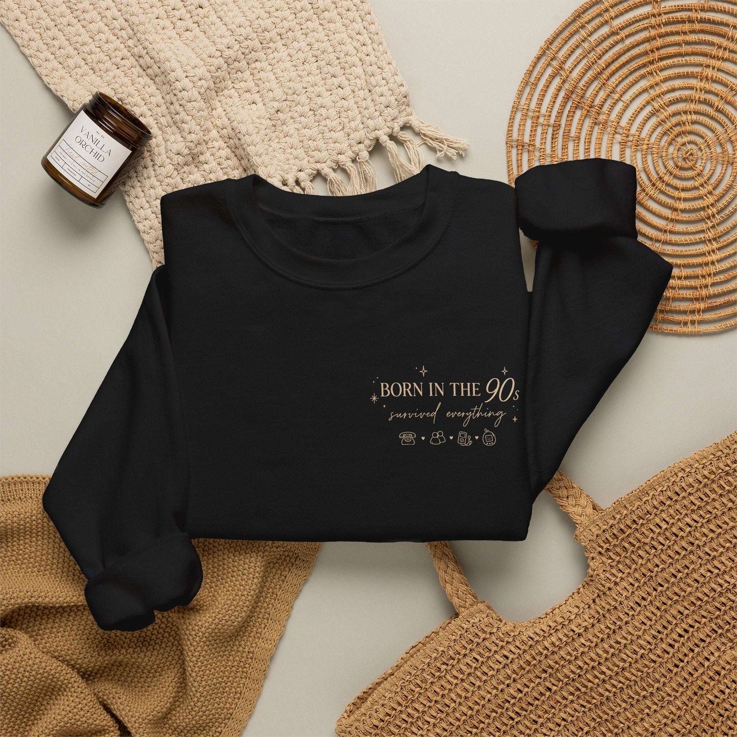 Black sweatshirt with a logo on a neutral background