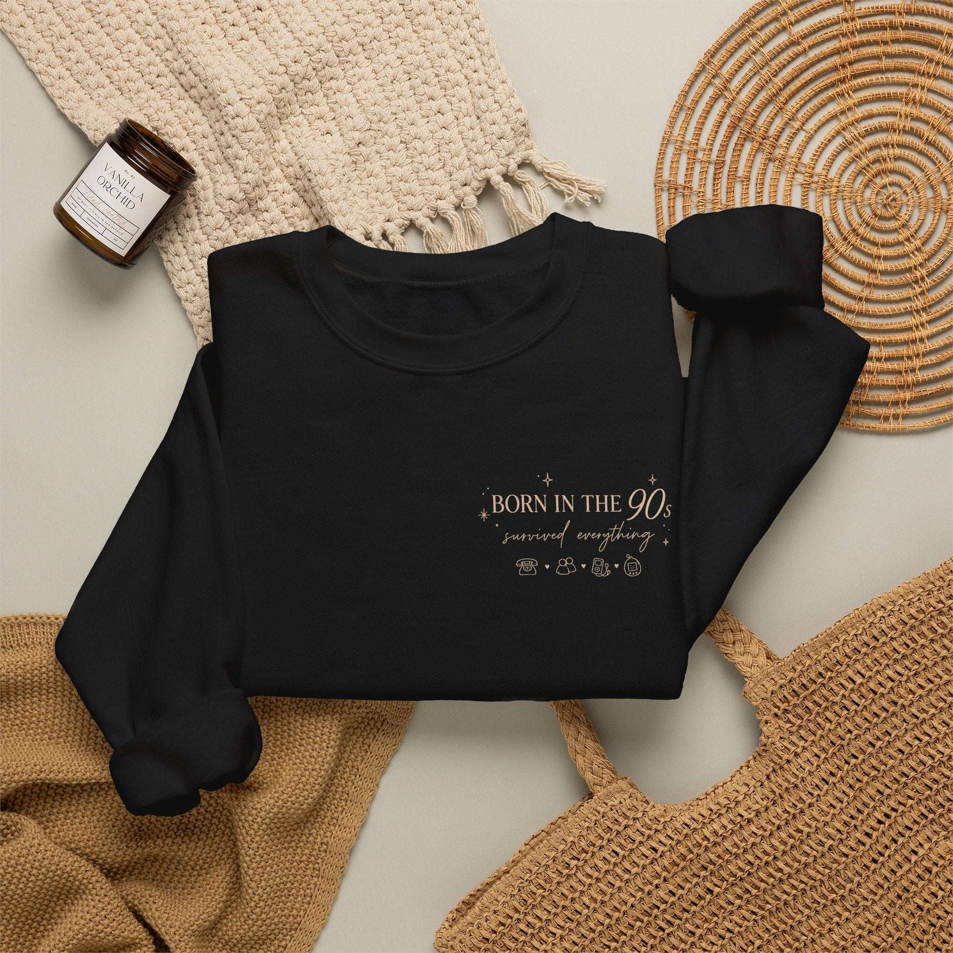 Black sweatshirt with a logo on a neutral background