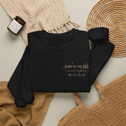 Black sweatshirt with a logo on a neutral background