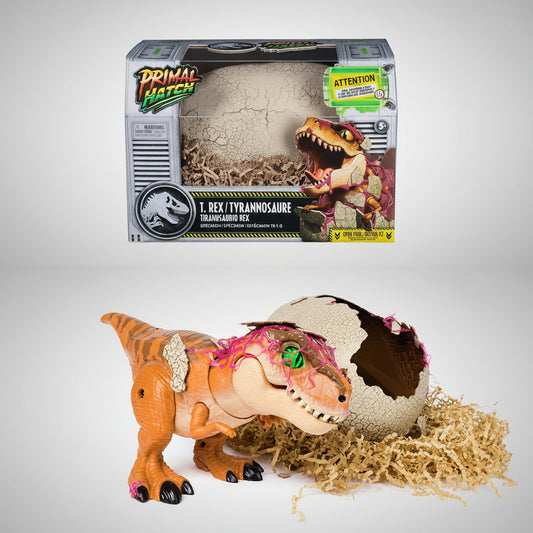 Toy T. Rex dinosaur with a cracked egg and packaging labeled 'Primal Hatch' on a white background.