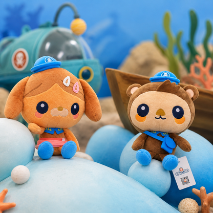 Two plush toys resembling a dog and a bear with blue hats on an underwater-themed background.