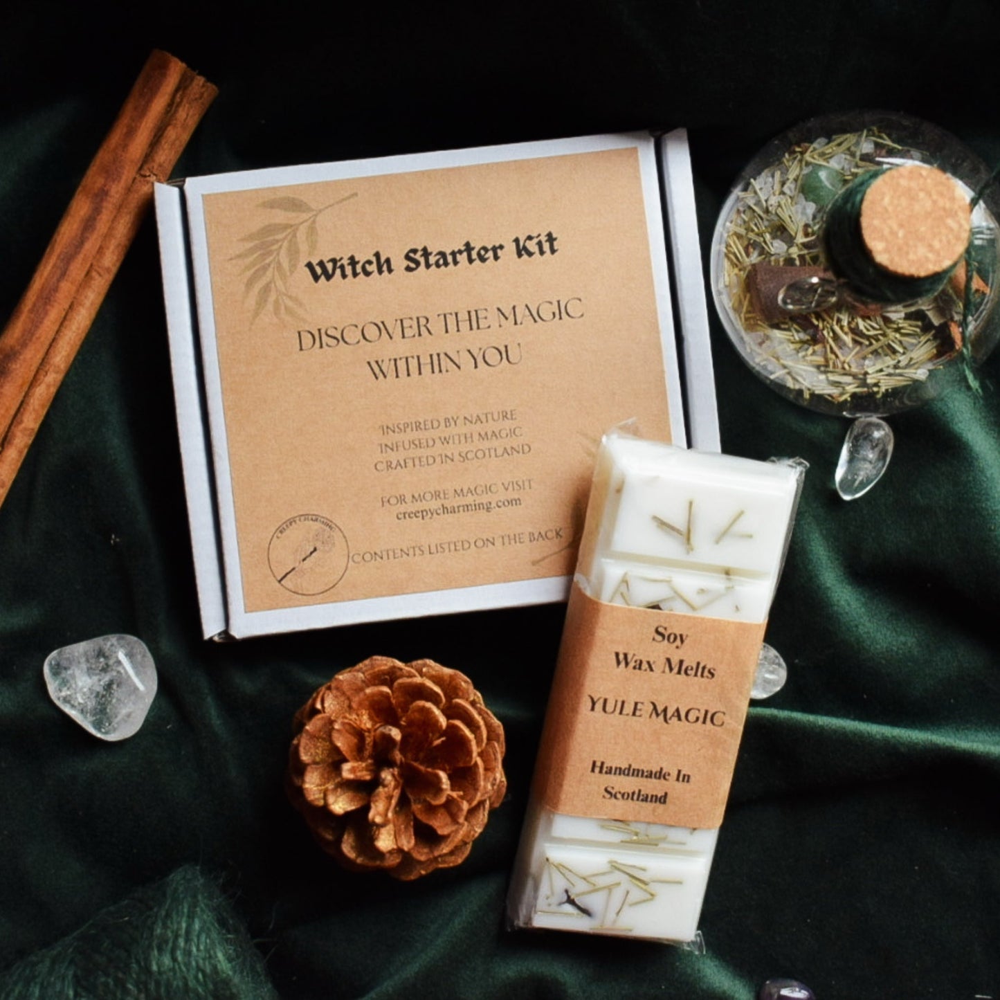 Witch Starter Kit with soy wax melts on a dark green fabric background
