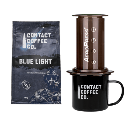 Contact Coffee Co. Blue Light coffee package with Aeropress and mug on a white background