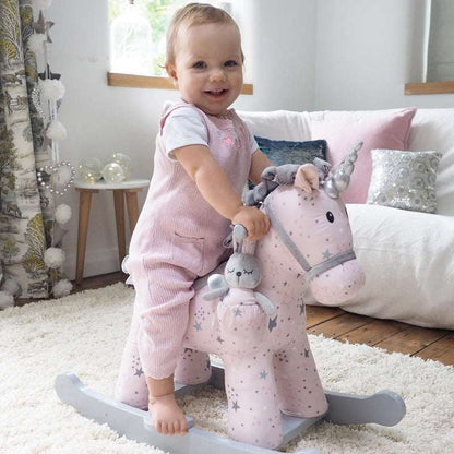 Child playing with a pink rocking horse toy in a cozy living room.