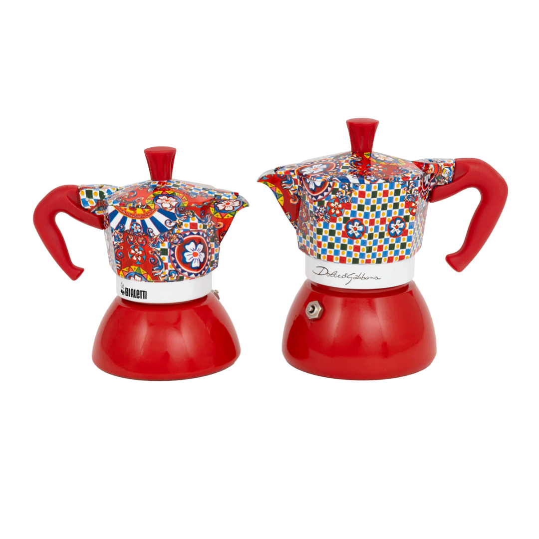 Two red coffee makers with colorful floral patterns on a white background