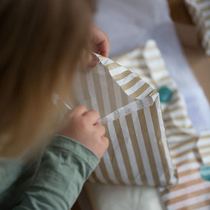 Child playing with a striped fabric toy