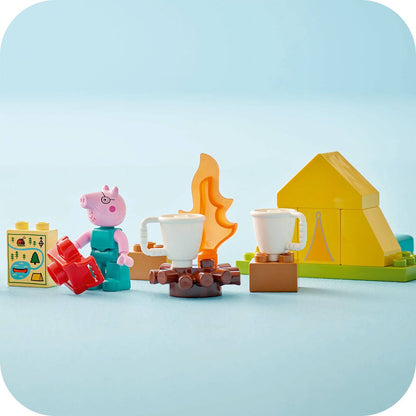 Toy set with a character, cups, and a tent on a light blue background