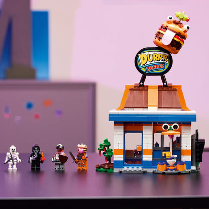 LEGO set with a burger shop and characters on a reflective surface