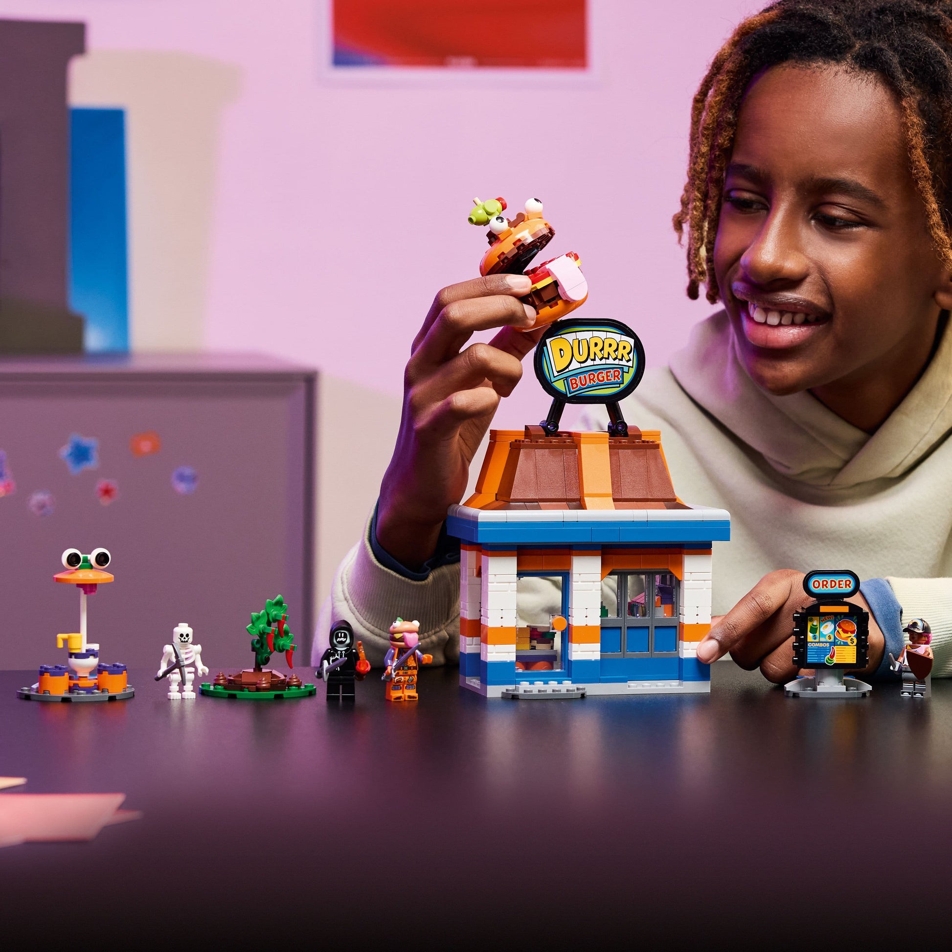 Child playing with a LEGO set featuring a small store and various characters.