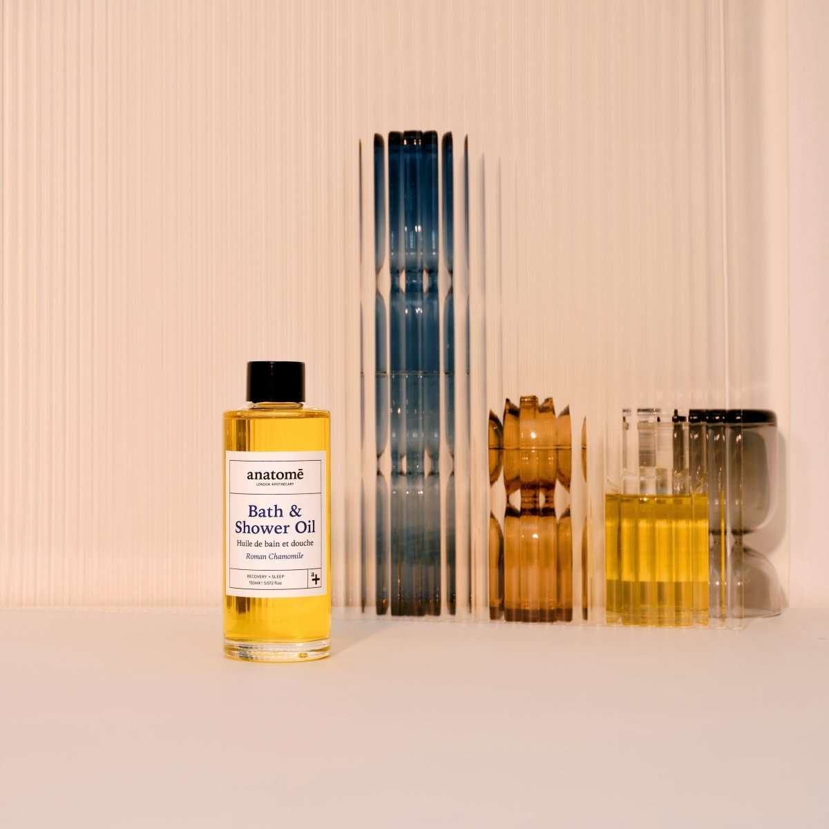 Bottle of anatomé Bath & Shower Oil on a neutral background