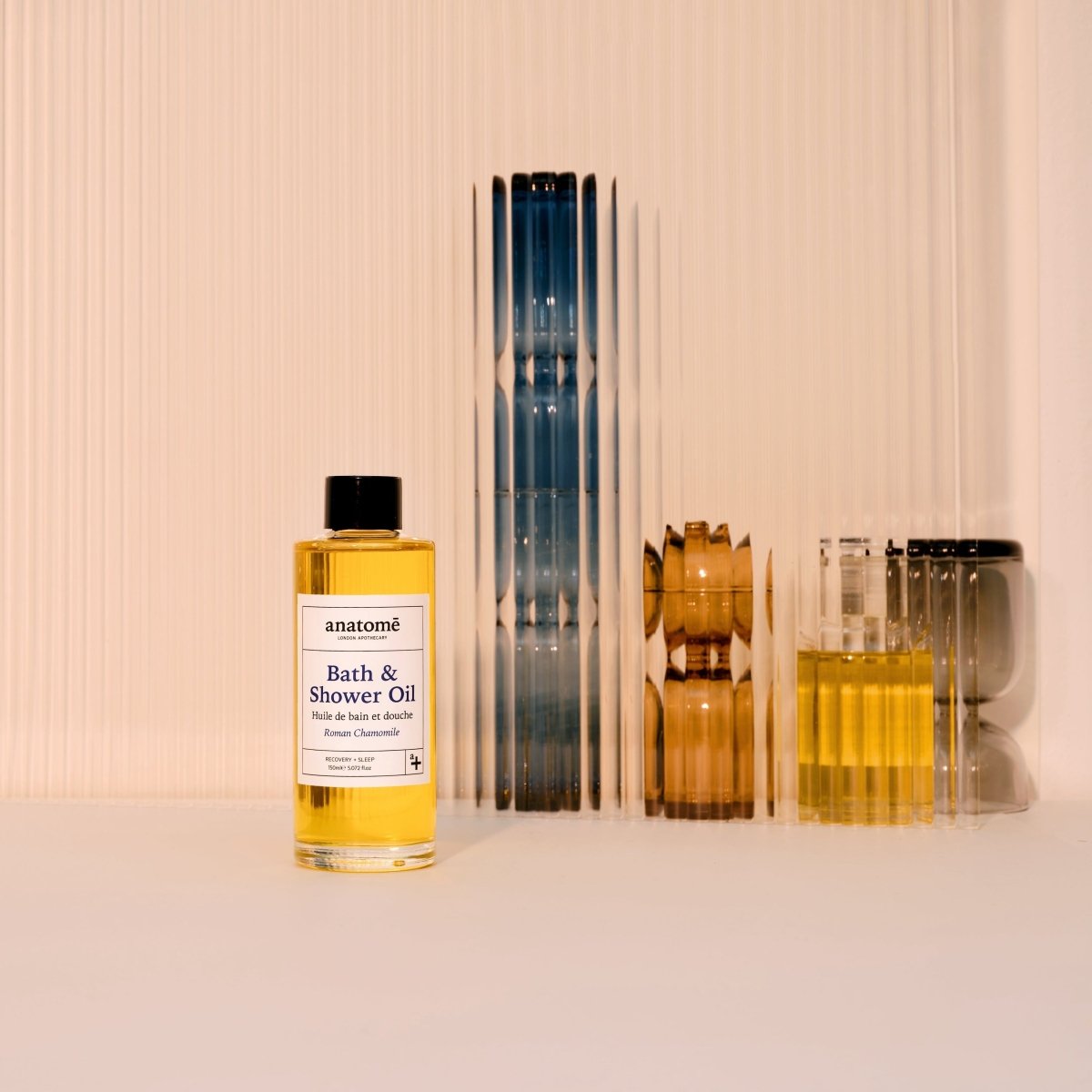 Bottle of anatomé Bath & Shower Oil on a neutral background