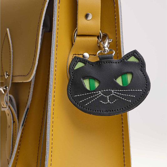 black cat bag charm on a yellow bag